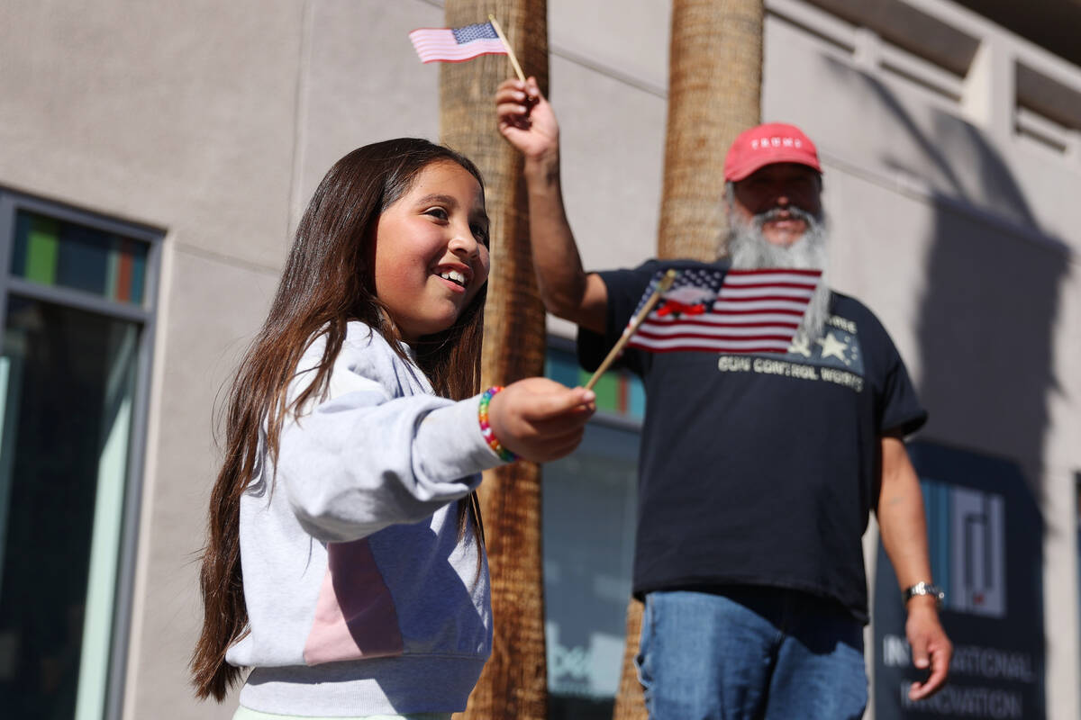 Audrey Curiel, 8, with her grandfather Steve Montez of Las Vegas, watch the Veterans Day parade ...