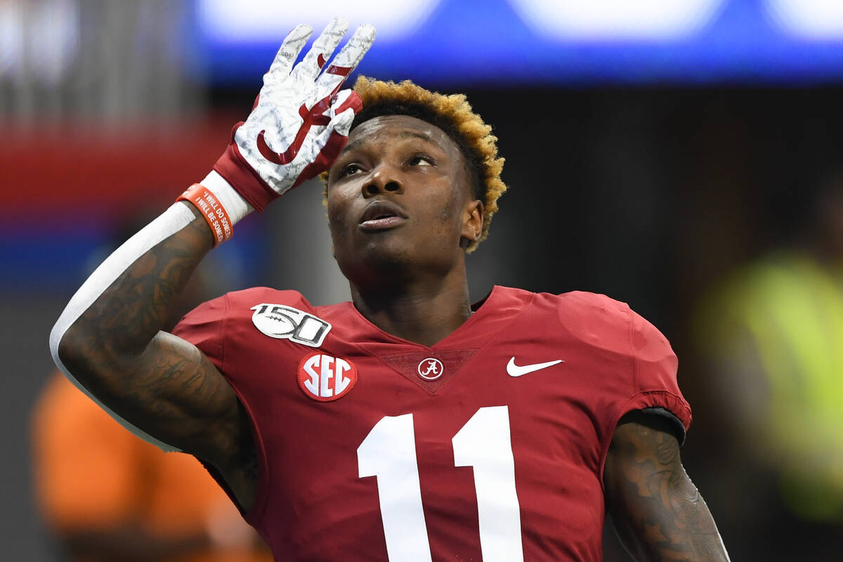 Alabama wide receiver Henry Ruggs III gestures during warmups for an NCAA football game against ...