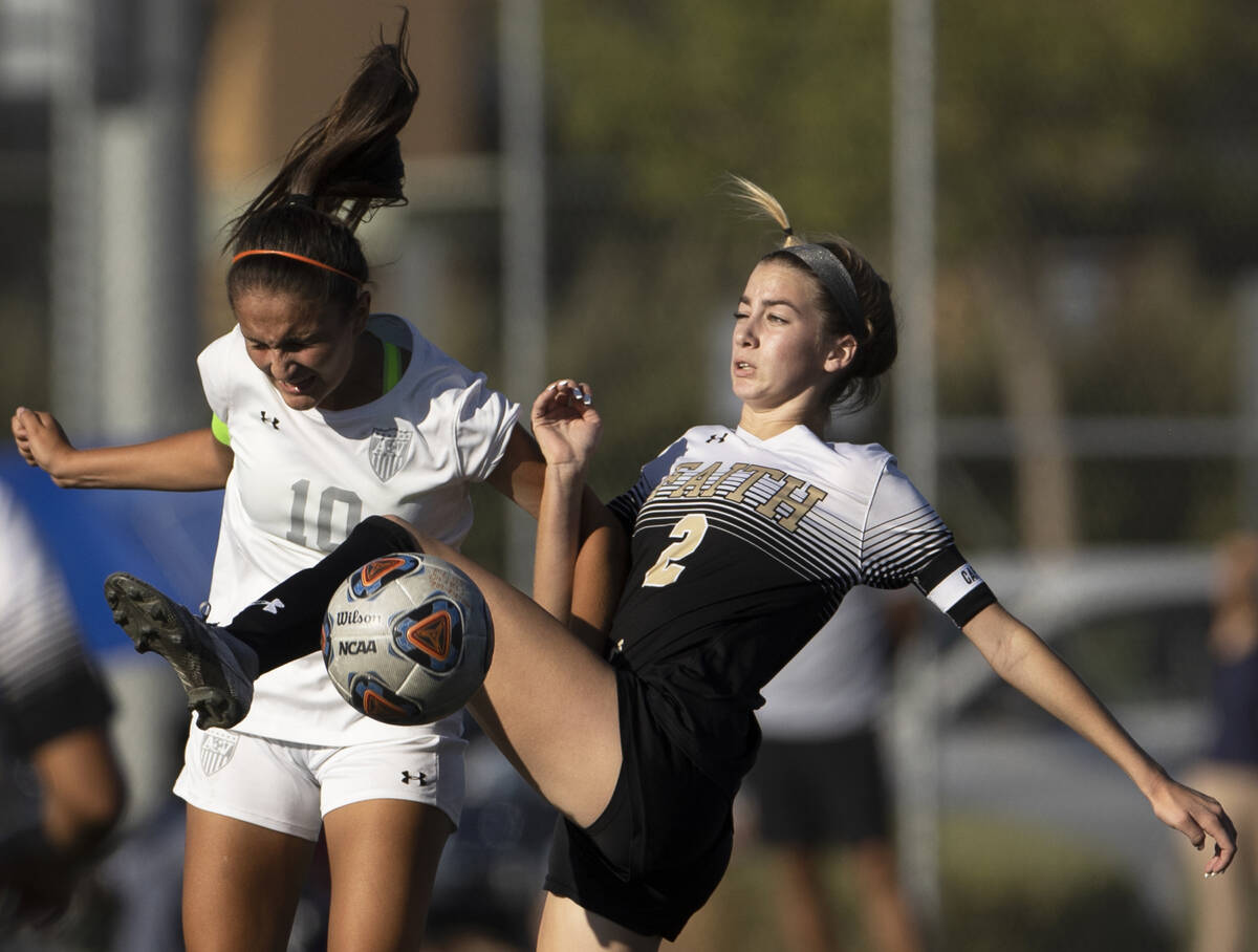 Arbor View’s Elisa Corvalan (10) and Faith Lutheran’s Taylor Day (2) fight for po ...