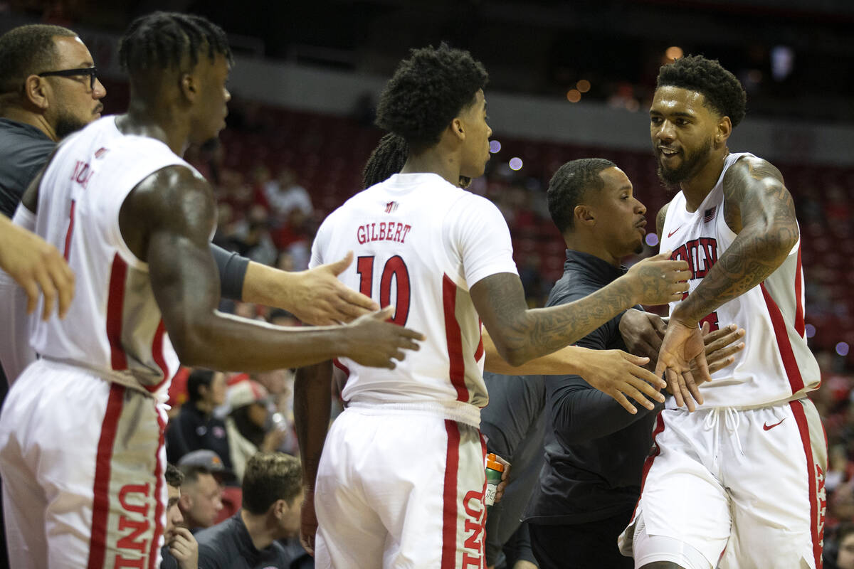 UNLV Rebels forward Royce Hamm Jr. (14) is welcomed to the bench by coaching staff, guard Kesho ...
