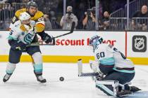 Seattle Kraken goaltender Chris Driedger (60) makes a save against Vegas Golden Knights left wi ...