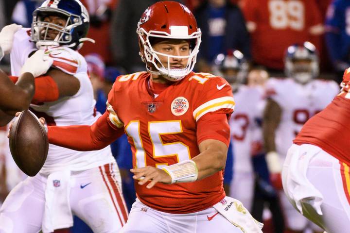 Kansas City Chiefs quarterback Patrick Mahomes (15) scrambles away from pressure during the fir ...