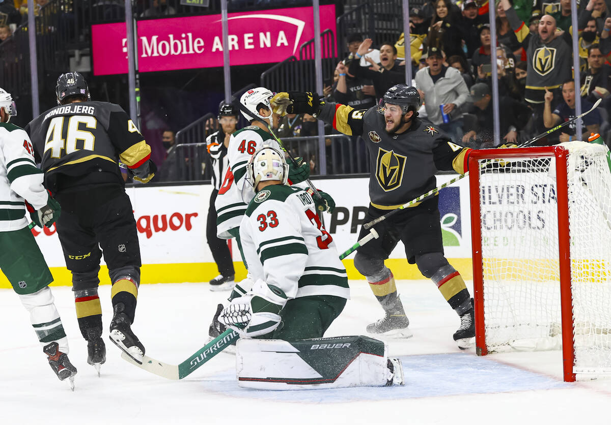 Golden Knights center Paul Cotter, right, celebrates a goal by right wing Jonas Rondbjerg (46) ...