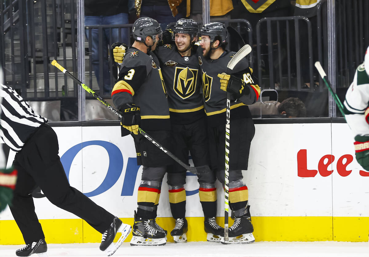 Golden Knights right wing Jonas Rondbjerg, center, celebrates his first NHL goal with defensema ...