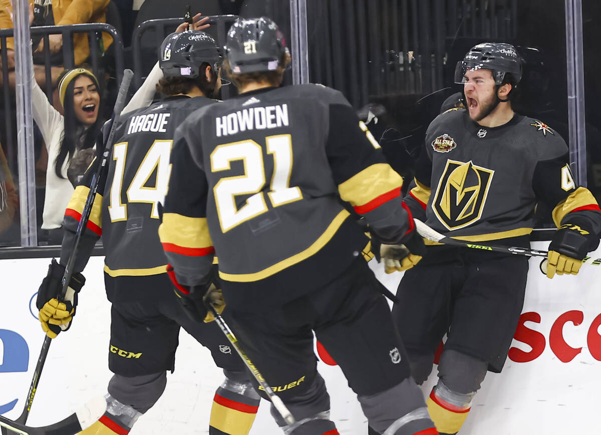 Golden Knights center Paul Cotter (43) celebrates his first NHL goal with teammates during the ...