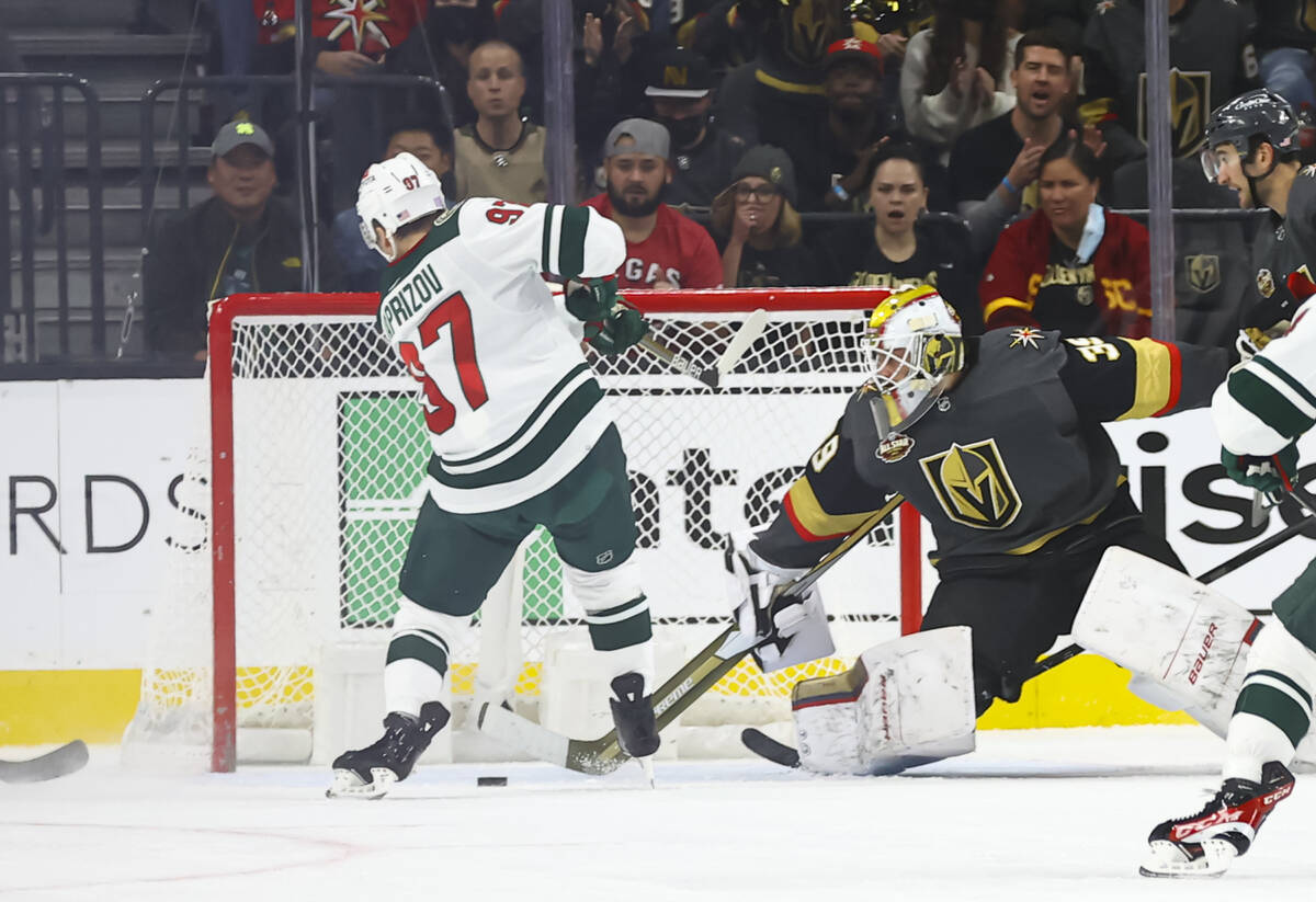 Golden Knights goaltender Laurent Brossoit (39) defends the net in front of Minnesota Wild left ...