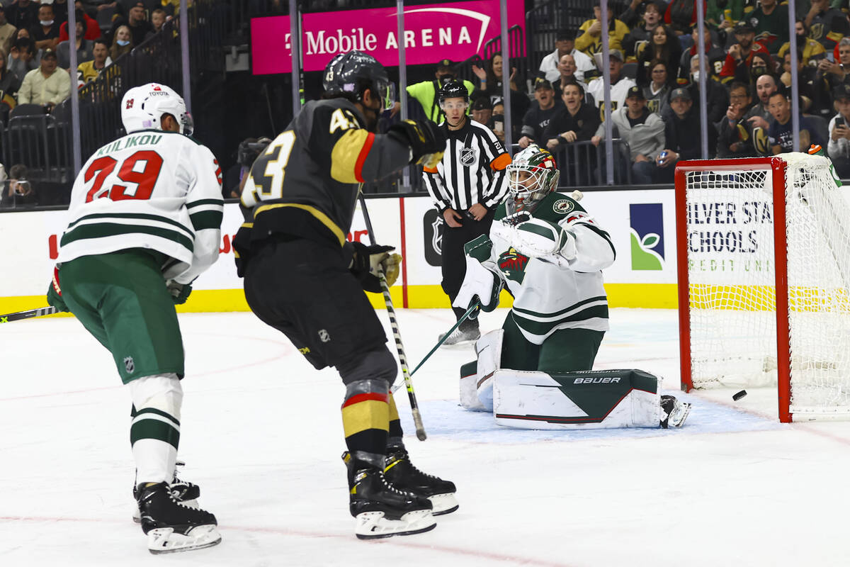 Golden Knights center Paul Cotter, left, scores a goal past Minnesota Wild goaltender Cam Talbo ...