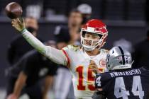 Kansas City Chiefs quarterback Patrick Mahomes (15) makes a running throw over Las Vegas Raider ...