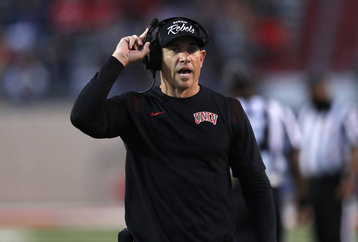 UNLV coach Marcus Arroyo walks the sidelines during the first half of an NCAA college football ...