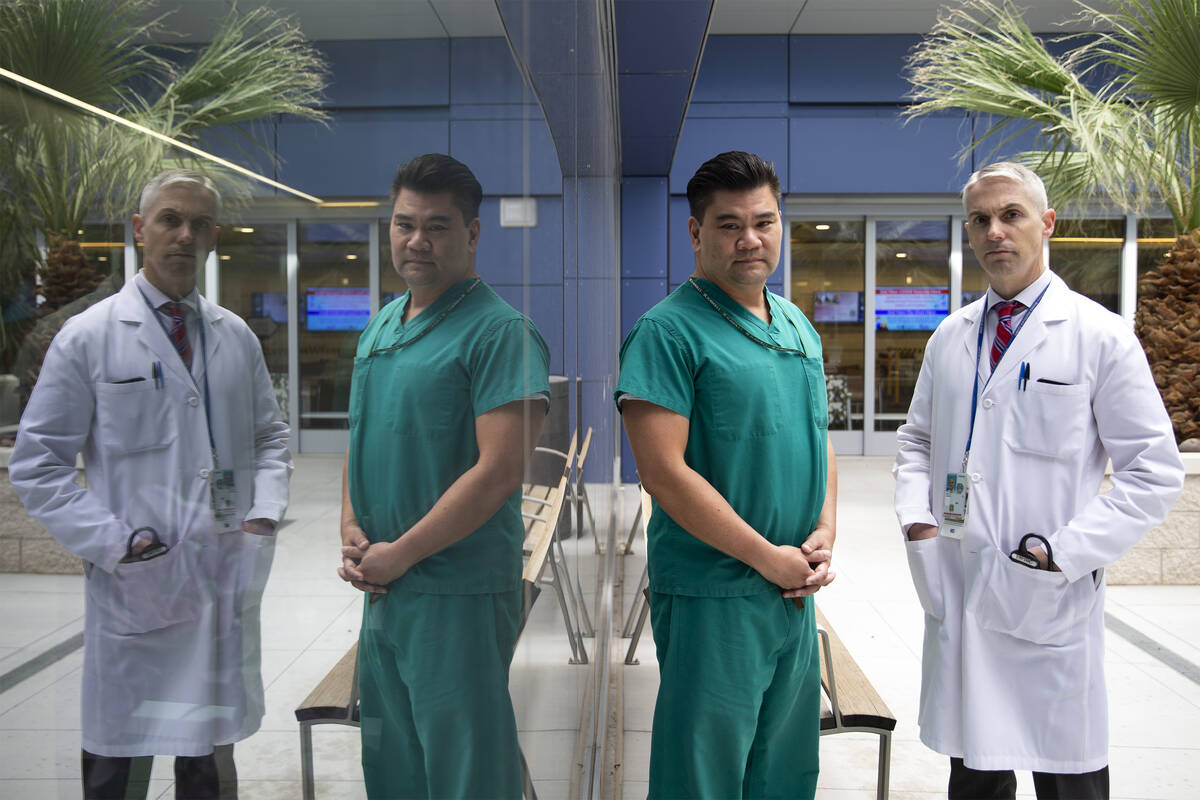 Dr. Myron Kung, a pulmonary critical care physician, left, and Dr. Jason Dazley, an infectious ...