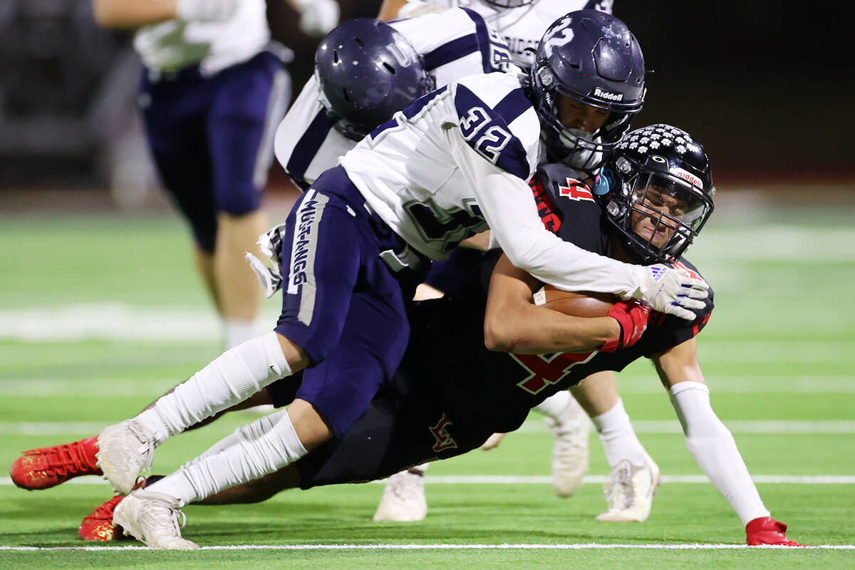 Las Vegas' Alvaro Zentino (4) is tackled by Shadow Ridge's Elijah Tooley (32) after a run in th ...