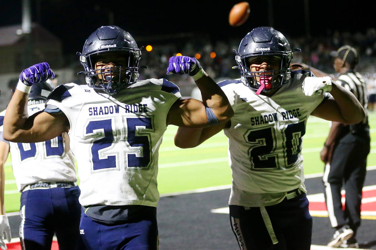 Shadow Ridge's Jaquieze Holland (25) celebrates his touchdown against Las Vegas with Devon Wood ...