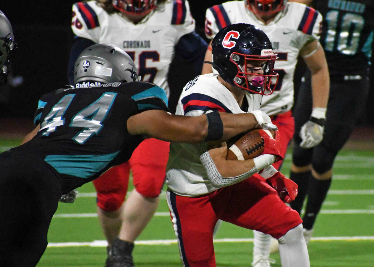 Silverado outside linebacker Chris Federico (44) attempts to strip the ball from Coronado&#x201 ...