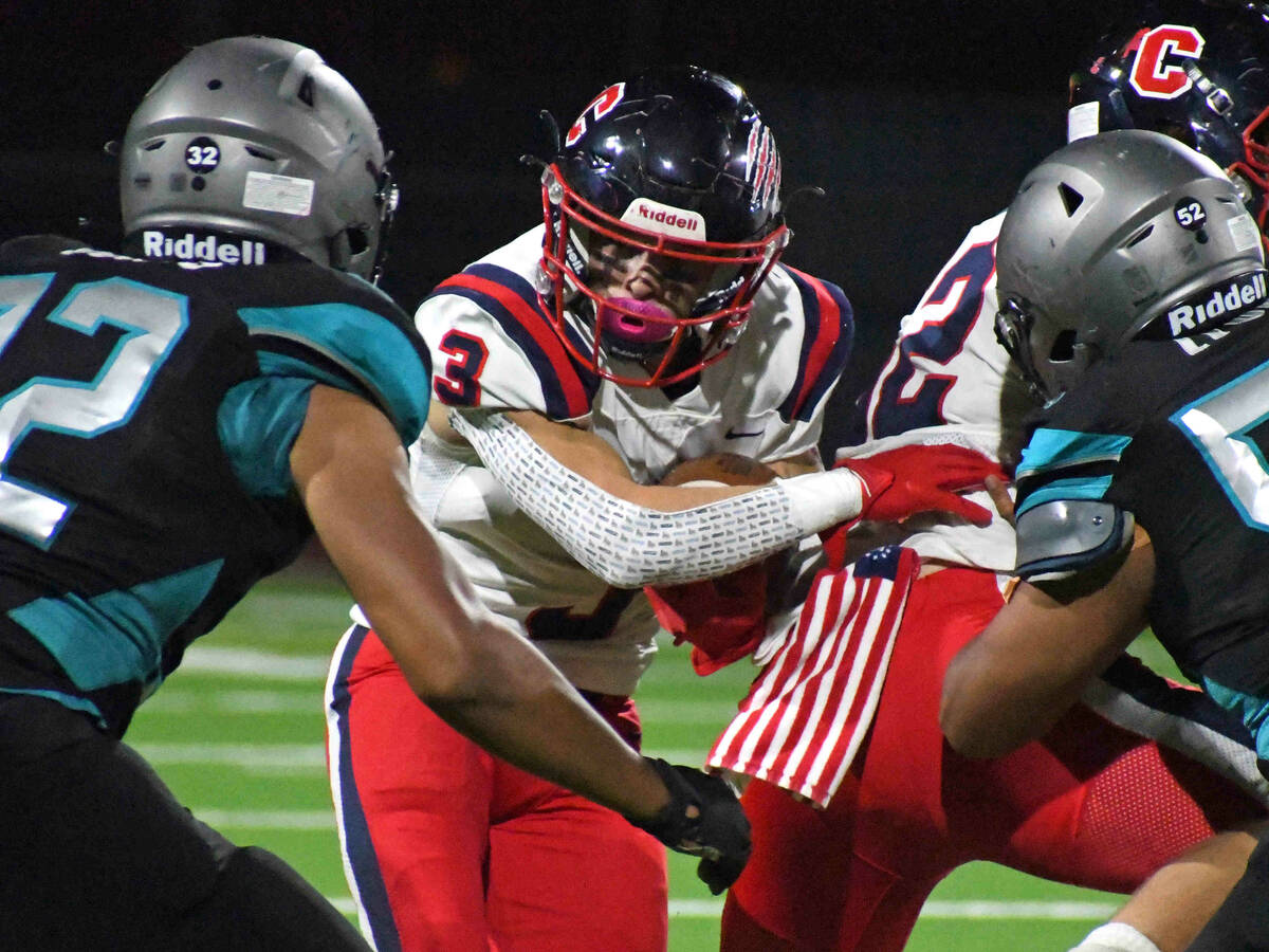 Coronado running back Chris Avila tries to find a hole in the Silverado defensive line during a ...