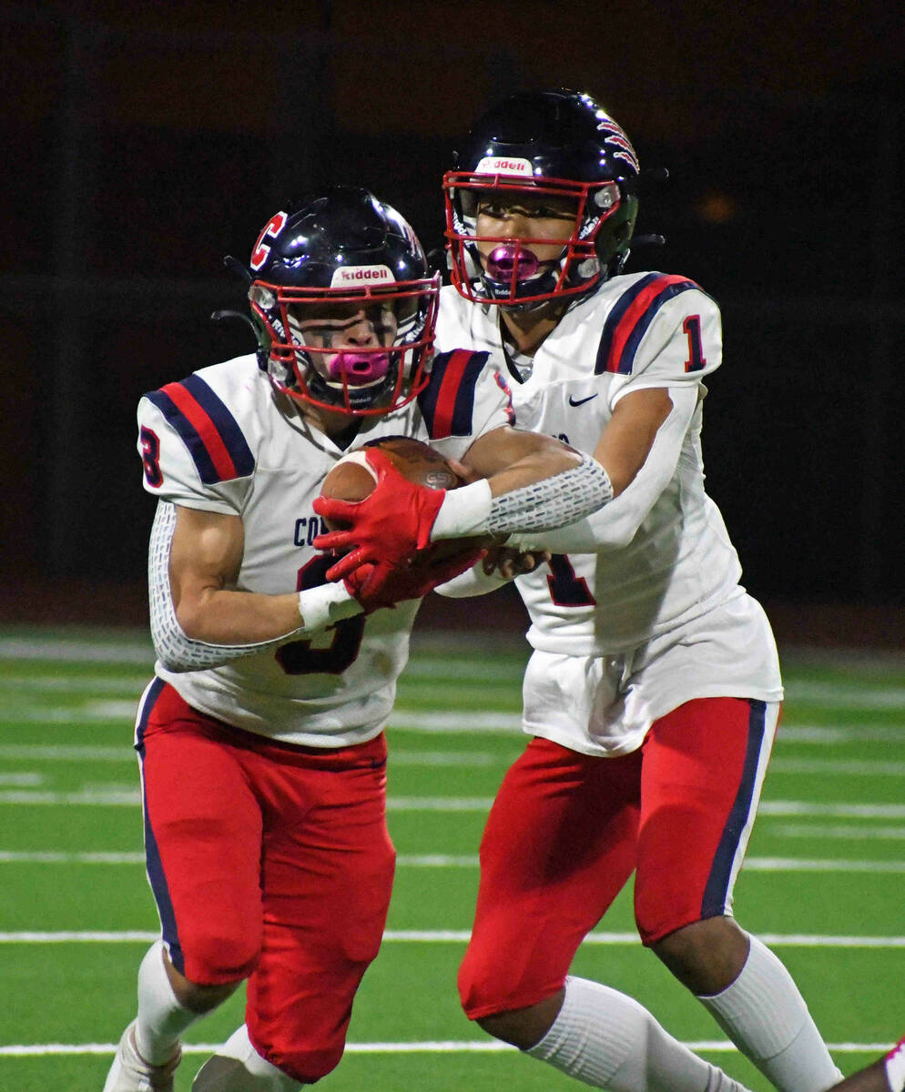 Coronado quarterback Joshua Andrade hands off to running back Chris Avila during a 4A state sem ...