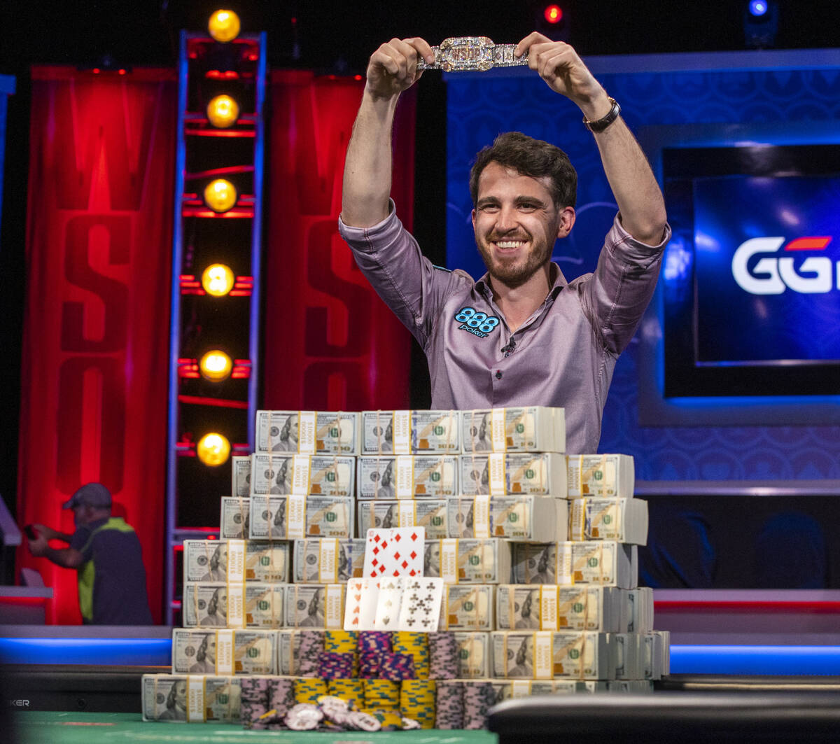Winner Koray Aldemir with his bracelet and stacks of cash at the final table for the $10,000 bu ...