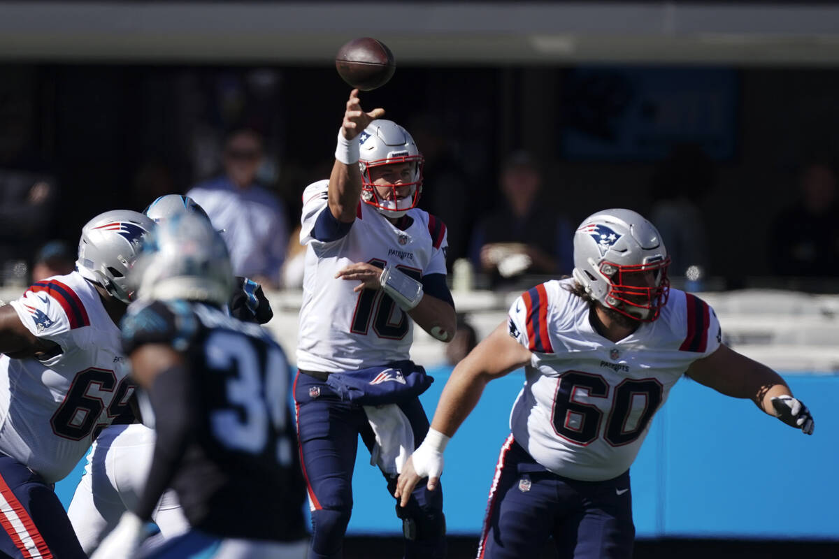 New England Patriots quarterback Mac Jones passes against the Carolina Panthers during the firs ...