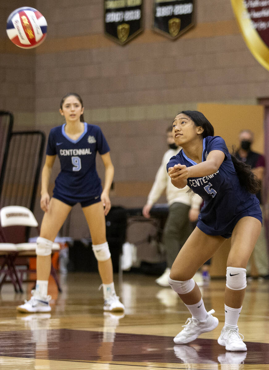 Centennial's Daphne Flores (5) bumps to Bishop Gorman as Mae Stoddard (9) looks on during the C ...