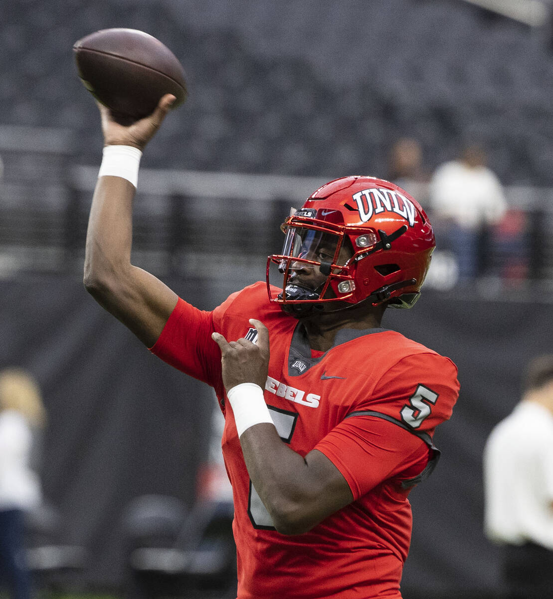 Rebels quarterback Justin Rogers (5) throws the ball as he warms up before an NCAA football gam ...