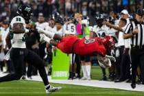 UNLV Rebels running back Charles Williams (8) dives to gain extra yards as Hawaii Warriors defe ...