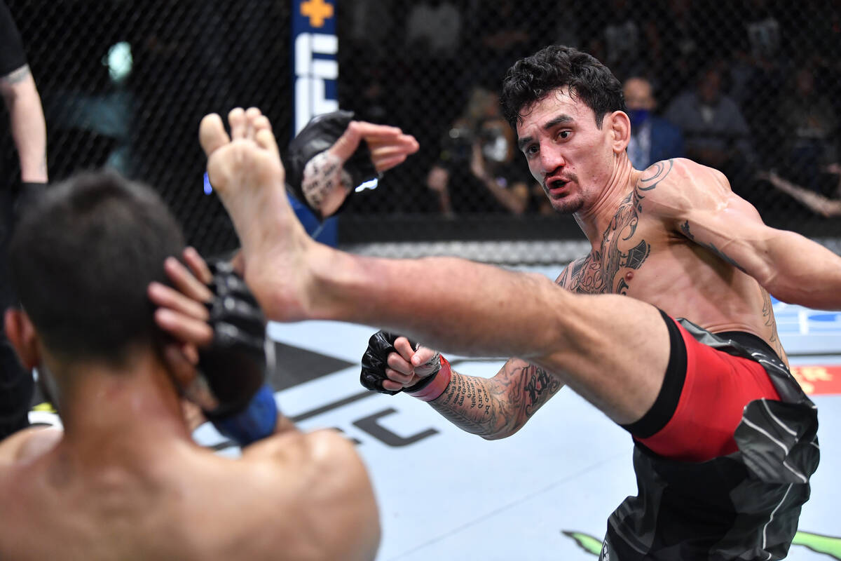 (R-L) Max Holloway kicks Yair Rodriguez of Mexico in a featherweight fight during the UFC Fight ...