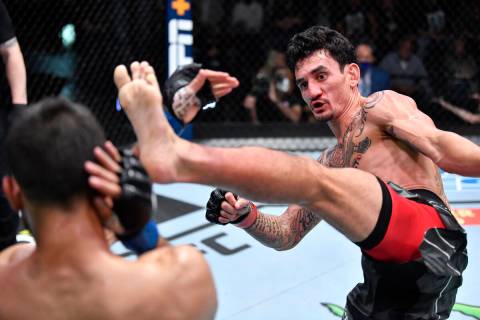 (R-L) Max Holloway kicks Yair Rodriguez of Mexico in a featherweight fight during the UFC Fight ...