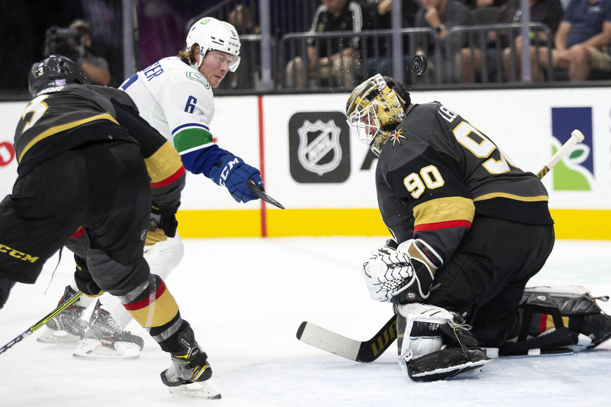 Golden Knights goaltender Robin Lehner (90) saves a shot on goal by Canucks right wing Brock Bo ...