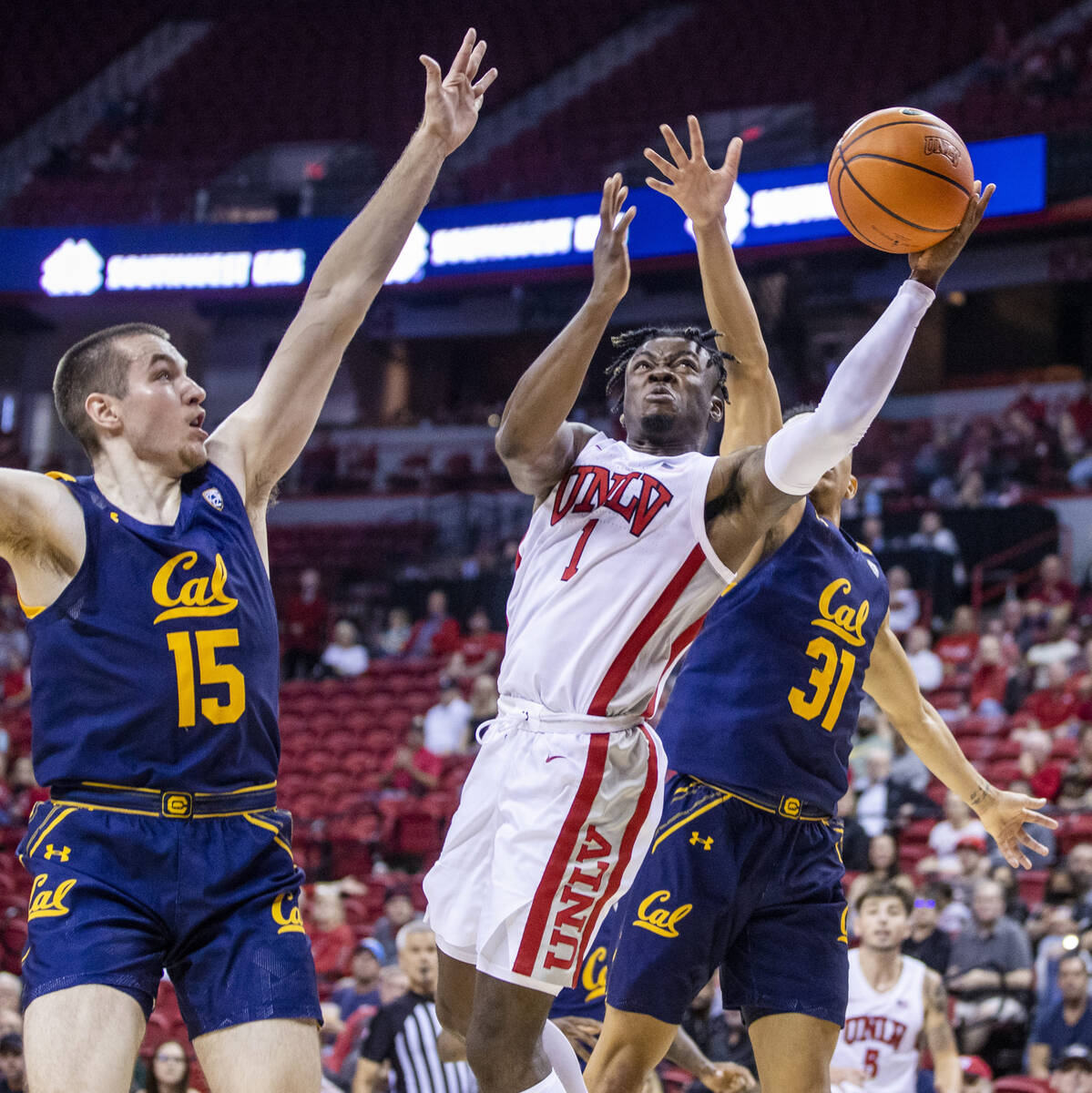 UNLV Rebels guard Mike Nuga (1) splits the defense of California Golden Bears forward Grant Ant ...