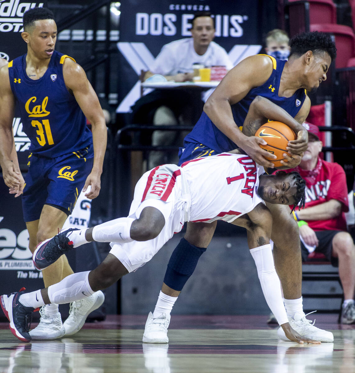 UNLV Rebels guard Mike Nuga (1) fights for a loose ball with California Golden Bears forward Mo ...