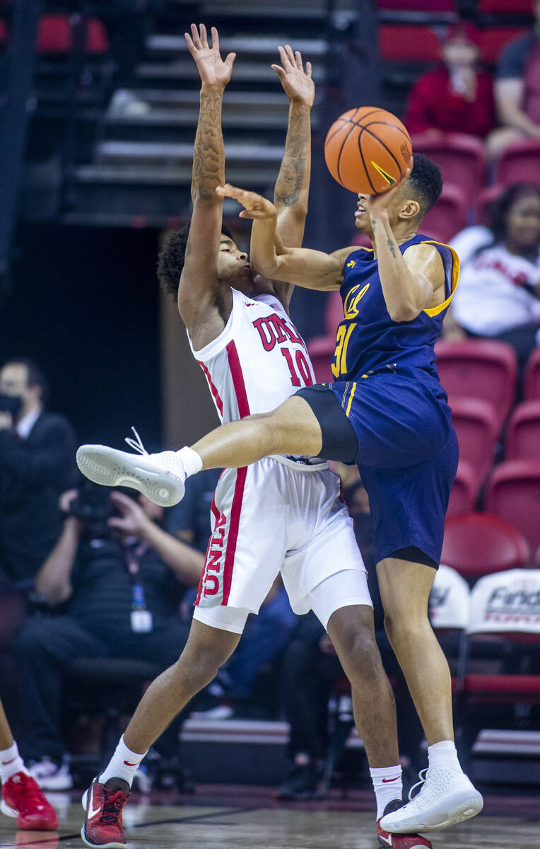 UNLV Rebels guard Keshon Gilbert (10) defends the lane from California Golden Bears guard Jorda ...