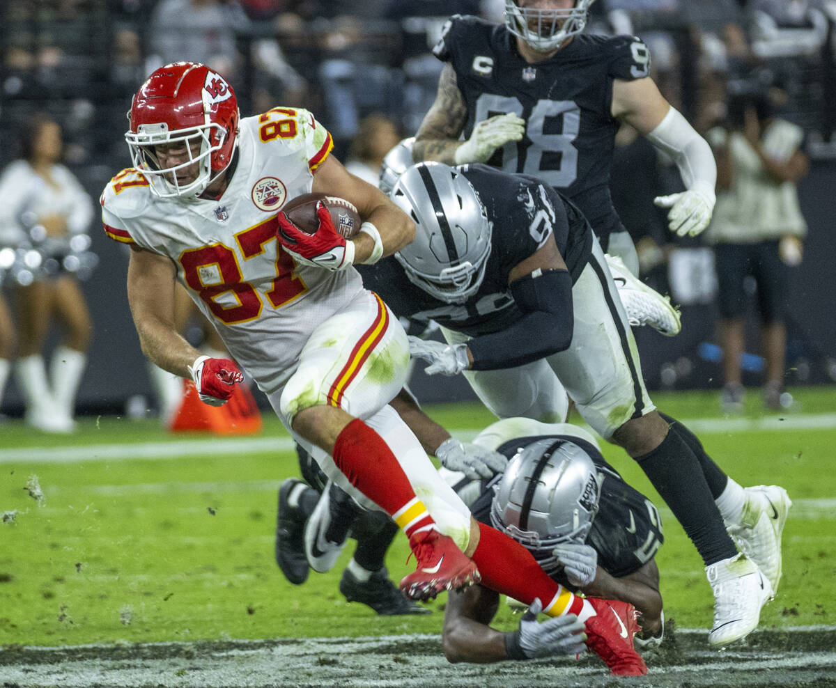 Kansas City Chiefs tight end Travis Kelce (87) escapes a tackle attempt by Raiders middle lineb ...