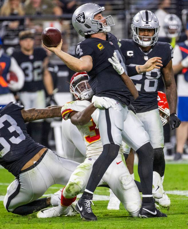 Raiders quarterback Derek Carr (4) is sacked by Kansas City Chiefs cornerback L'Jarius Sneed (3 ...