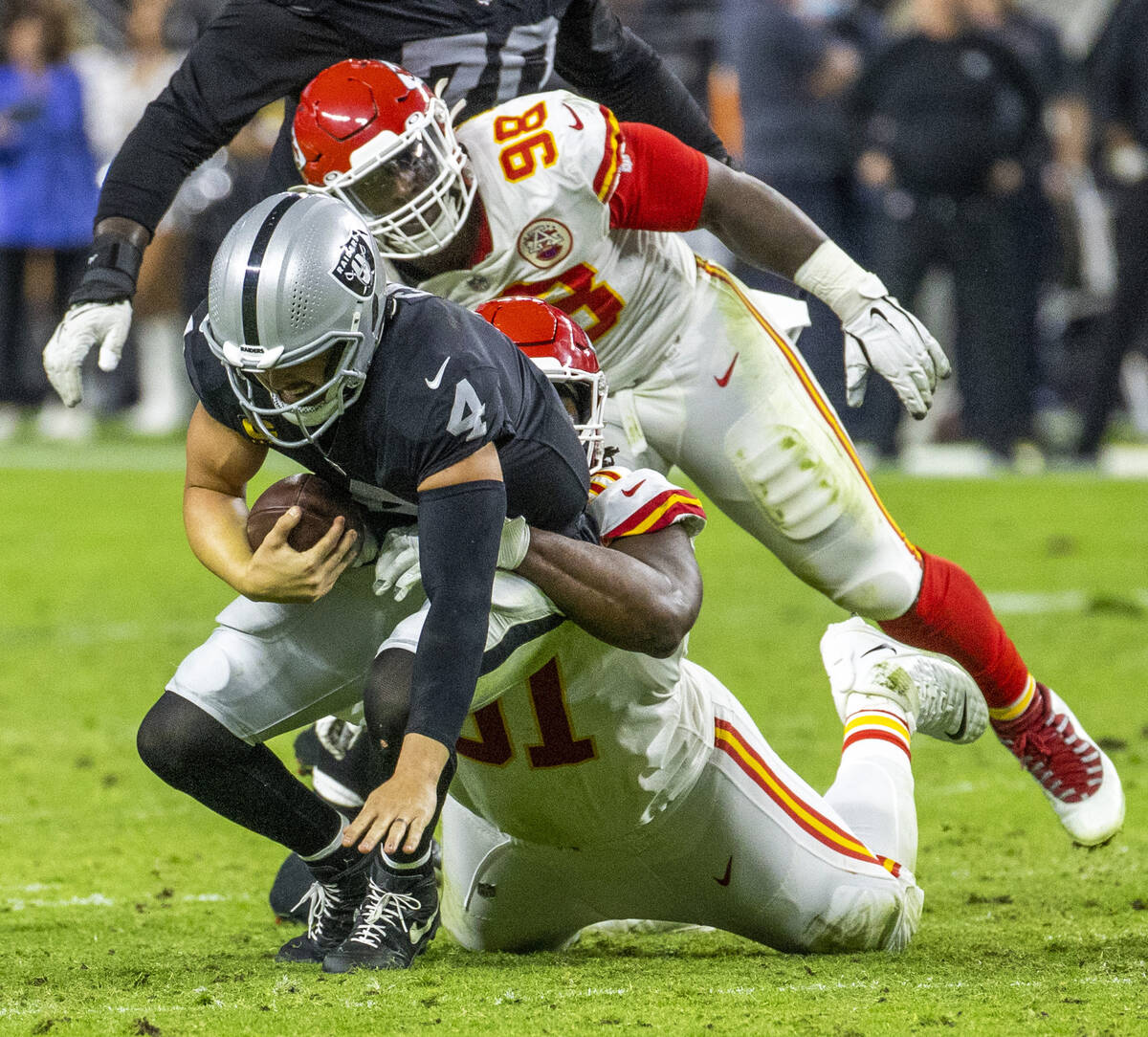 Raiders quarterback Derek Carr (4) is sacked by Kansas City Chiefs defensive tackle Derrick Nna ...