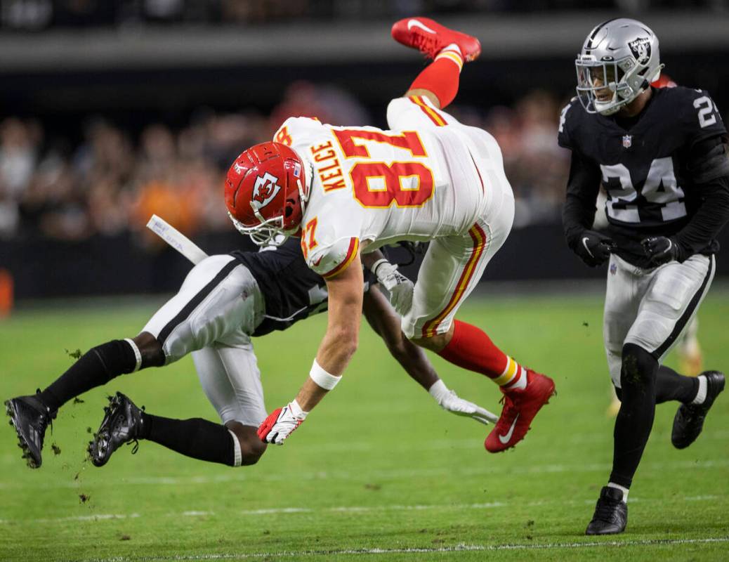 Kansas City Chiefs tight end Travis Kelce (87) is tackled by Raiders safety Johnathan Abram (24 ...