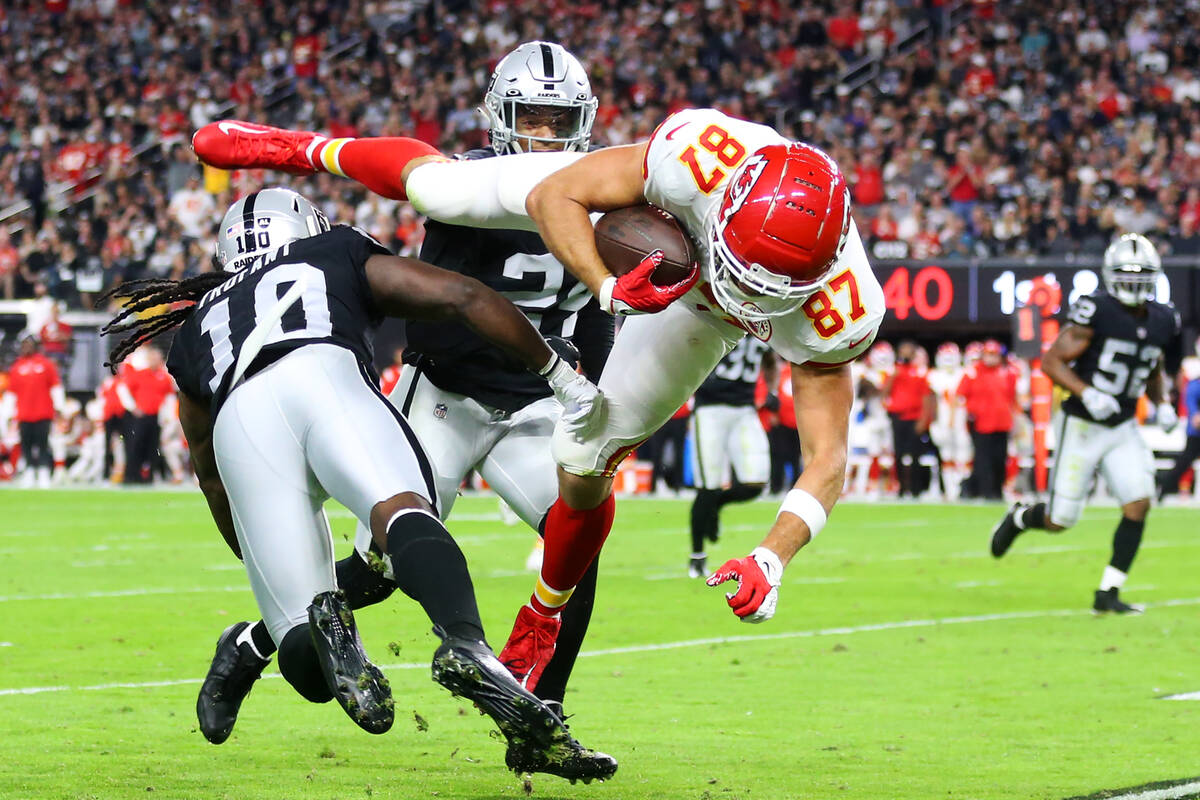 Raiders cornerback Desmond Trufant (10) tackles Kansas City Chiefs tight end Travis Kelce (87) ...