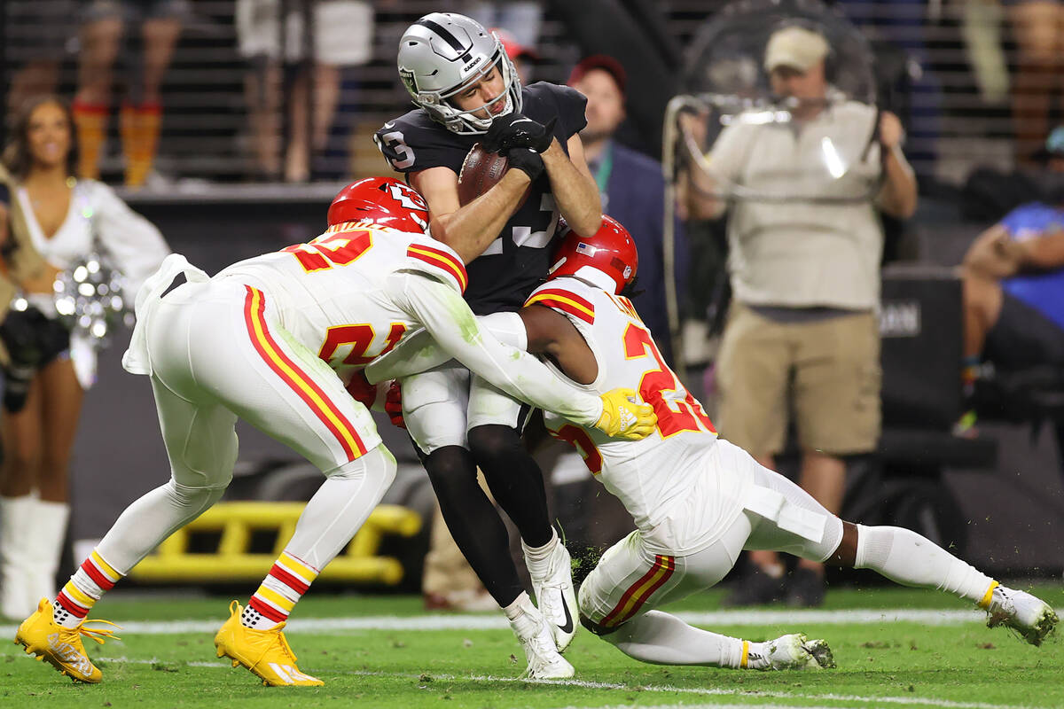 Kansas City Chiefs safety Juan Thornhill (22) and defensive back Chris Lammons (26) tackle Raid ...