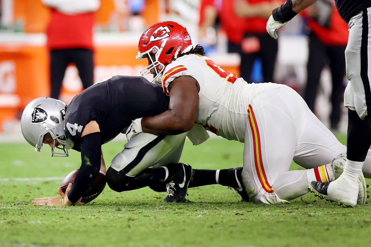 Raiders quarterback Derek Carr (4) is sacked by Kansas City Chiefs defensive tackle Derrick Nna ...