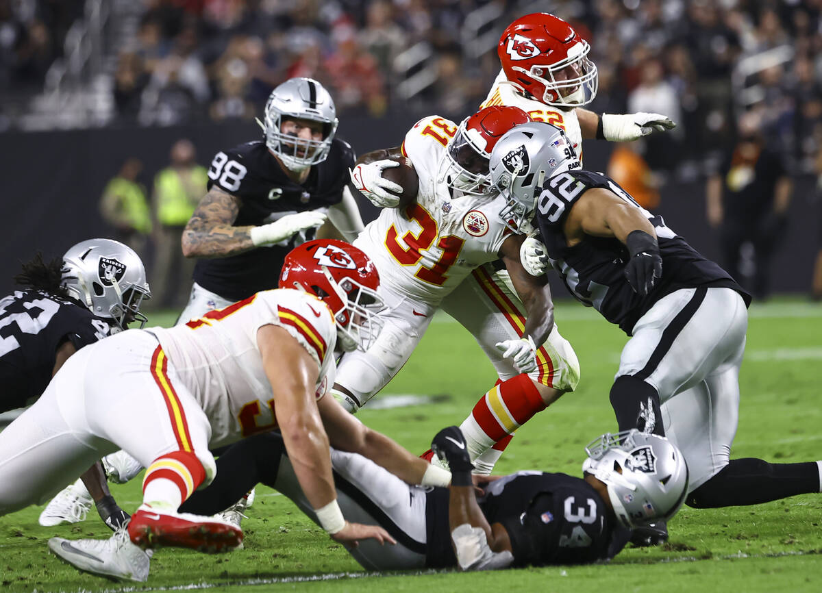 Kansas City Chiefs running back Darrel Williams (31) gets stopped by Raiders defensive end Solo ...