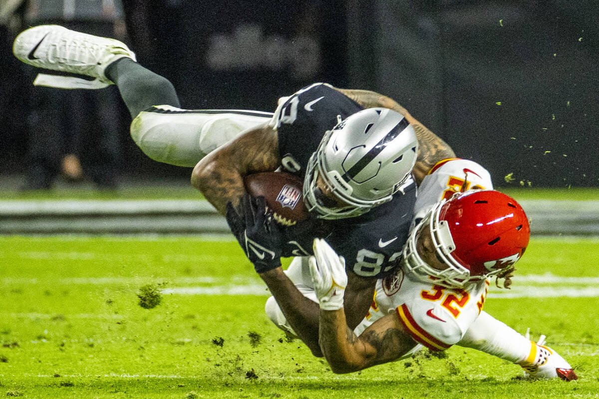 Raiders tight end Darren Waller (83) is tackled by Kansas City Chiefs free safety Tyrann Mathie ...