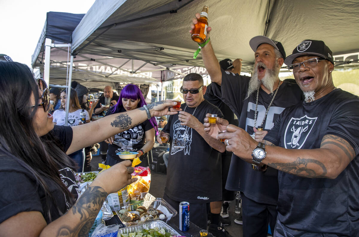 Raiders fans stock  shots successful  tailgating earlier  an NFL crippled  versus the Kansas City Chiefs astatine  Alle ...