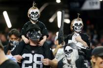 Fans pose for a photo before the start of an NFL football game between the Raiders and Kansas C ...