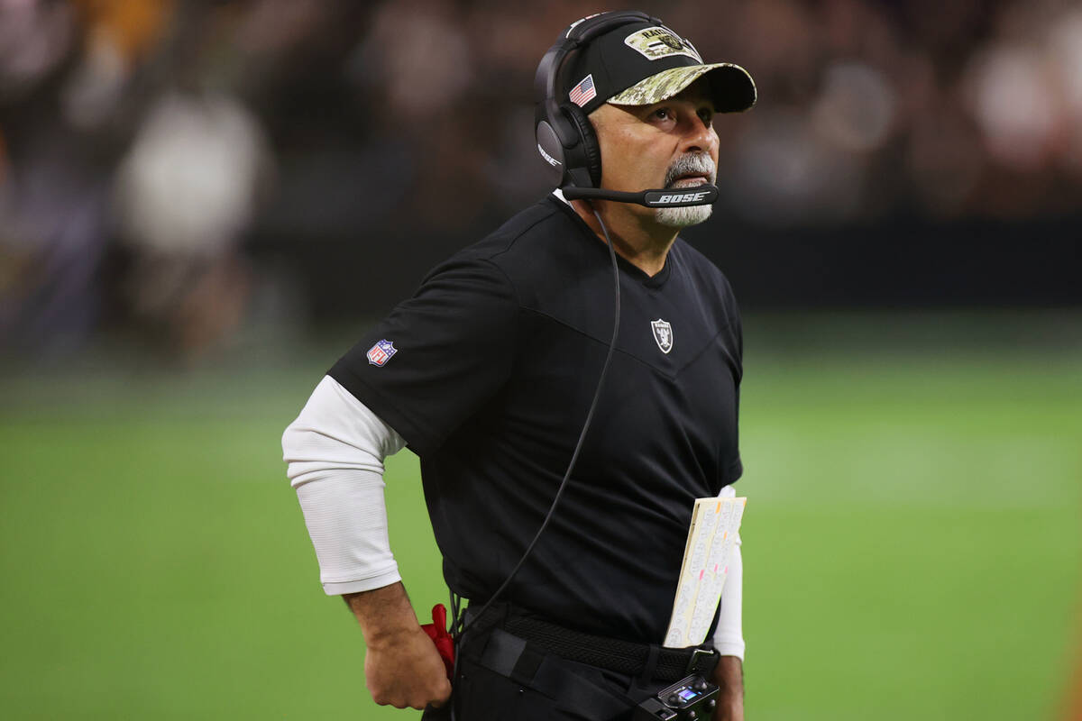 Kansas City Chiefs head coach Andy Reid watches a game replay while holding the challenge flag ...