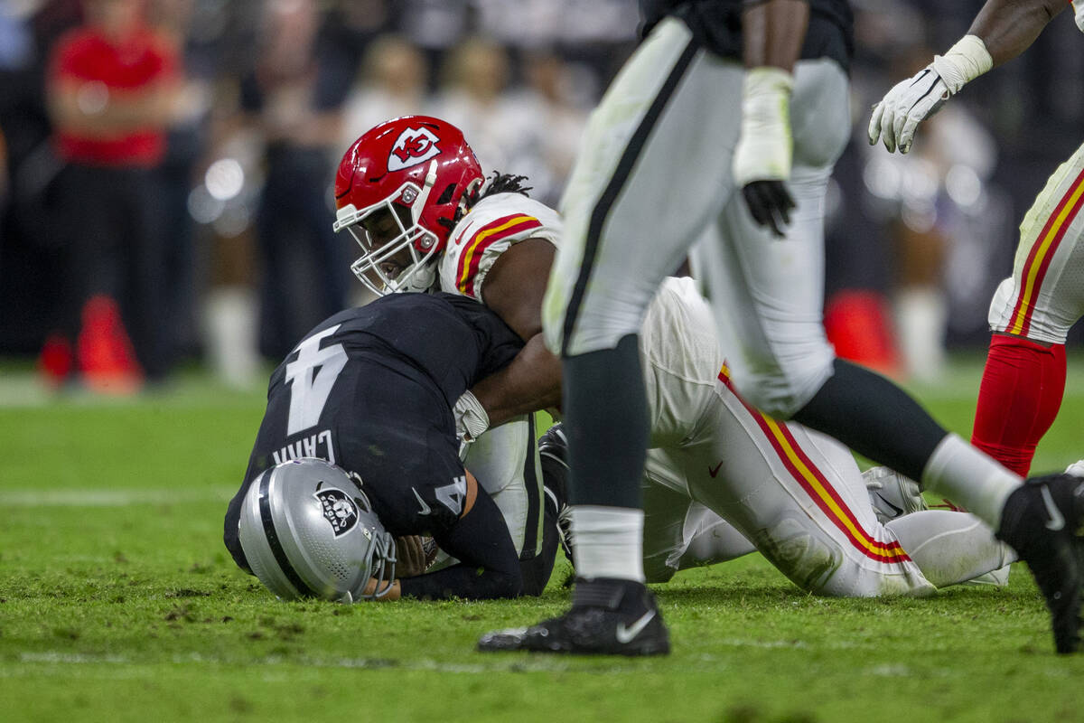 Raiders quarterback Derek Carr (4) is sacked by Kansas City Chiefs defensive tackle Derrick Nna ...