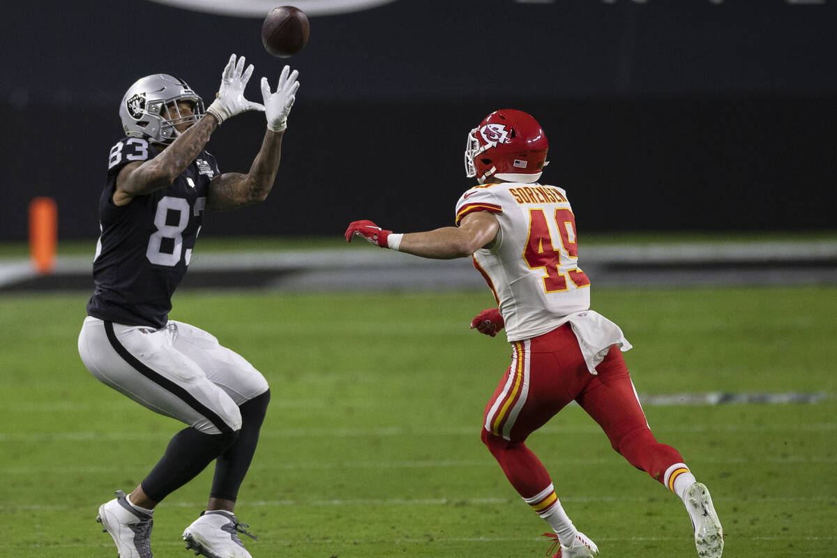Las Vegas Raiders tight end Darren Waller (83) makes a catch over Kansas City Chiefs free safet ...