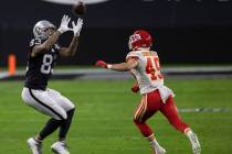 Las Vegas Raiders tight end Darren Waller (83) makes a catch over Kansas City Chiefs free safet ...