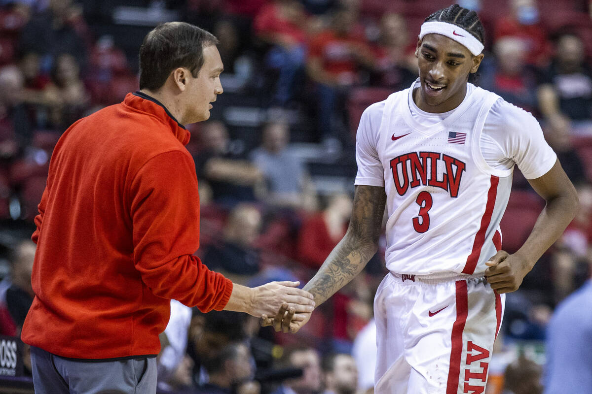 UNLV Rebels head coach Kevin Kruger praises UNLV Rebels forward Donovan Williams (3) as he come ...