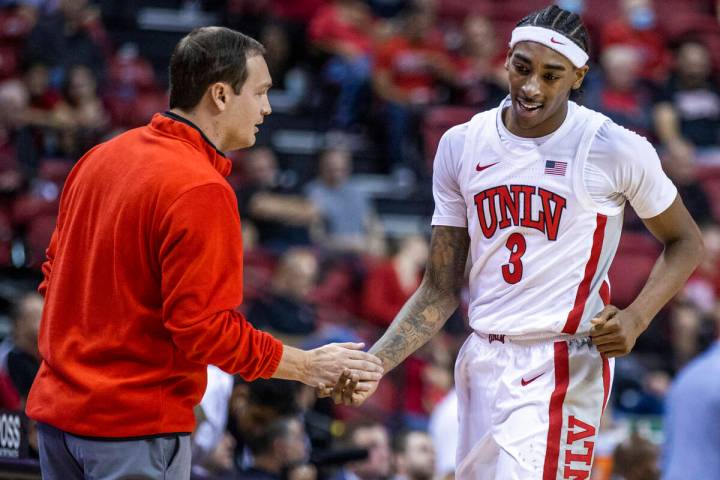 UNLV Rebels head coach Kevin Kruger praises UNLV Rebels forward Donovan Williams (3) as he come ...