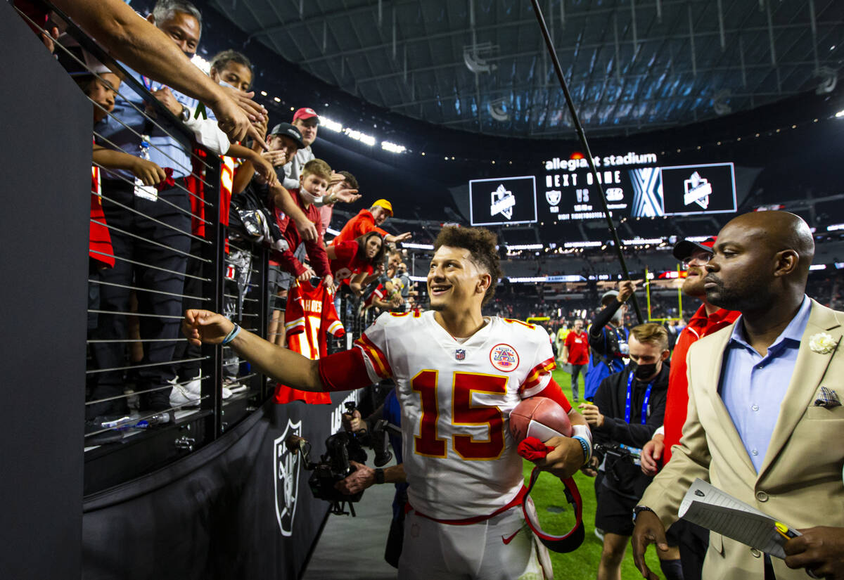 Kansas City Chiefs quarterback Patrick Mahomes (15) celebrates with fans after defeating the Ra ...
