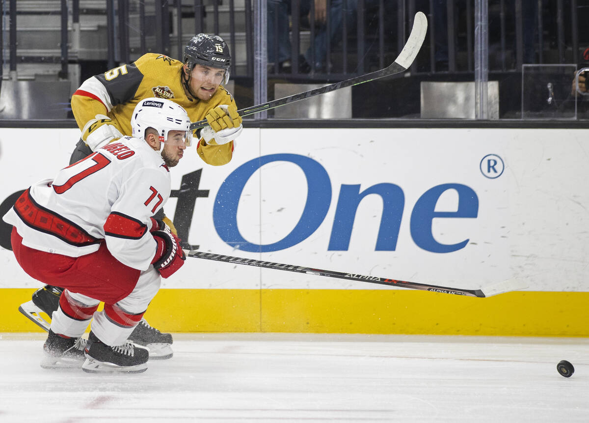 Golden Knights center Jake Leschyshyn (15) shoots past Carolina Hurricanes defenseman Tony DeAn ...