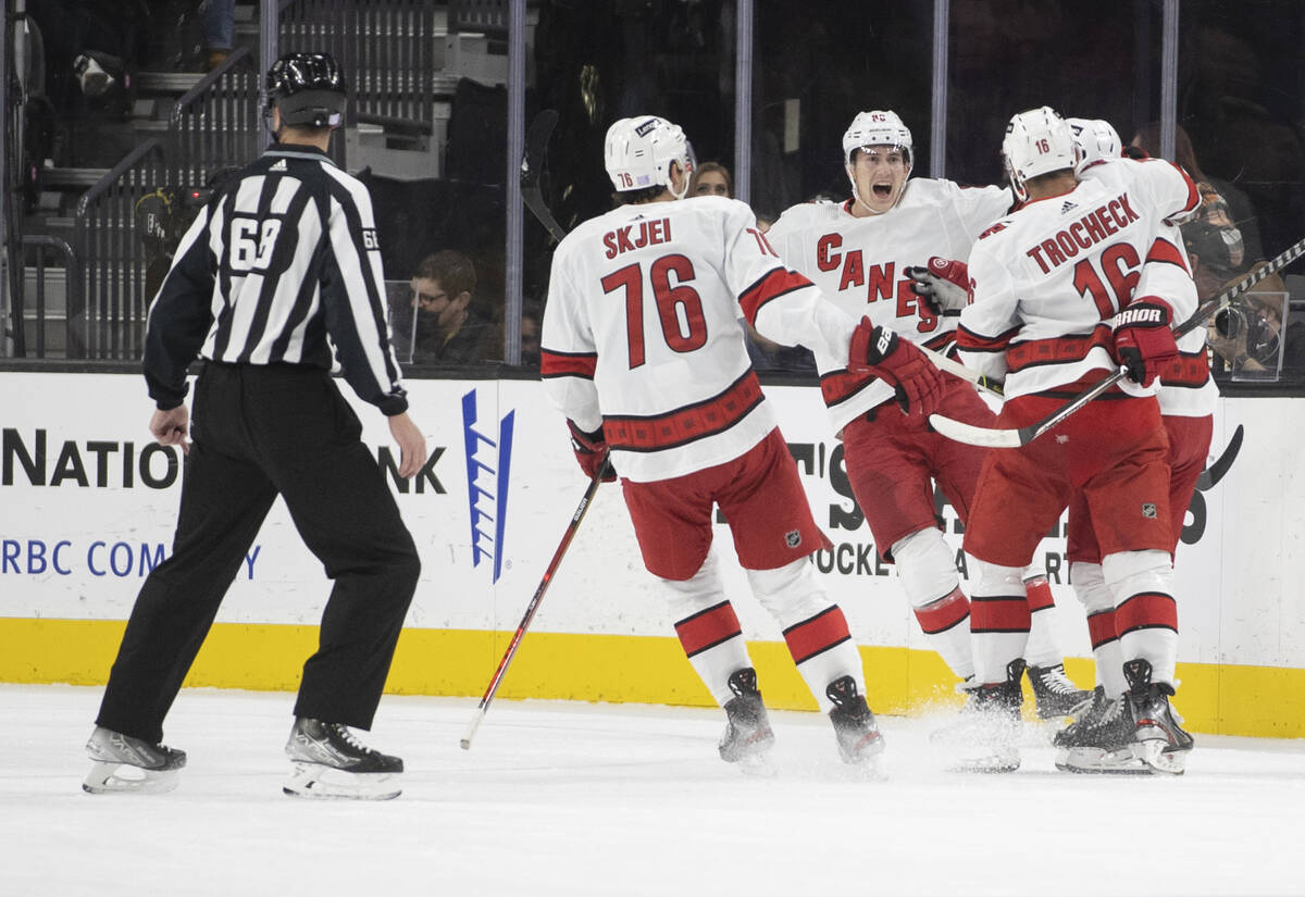 Carolina Hurricanes players celebrate a goal in the first period during an NHL hockey game agai ...